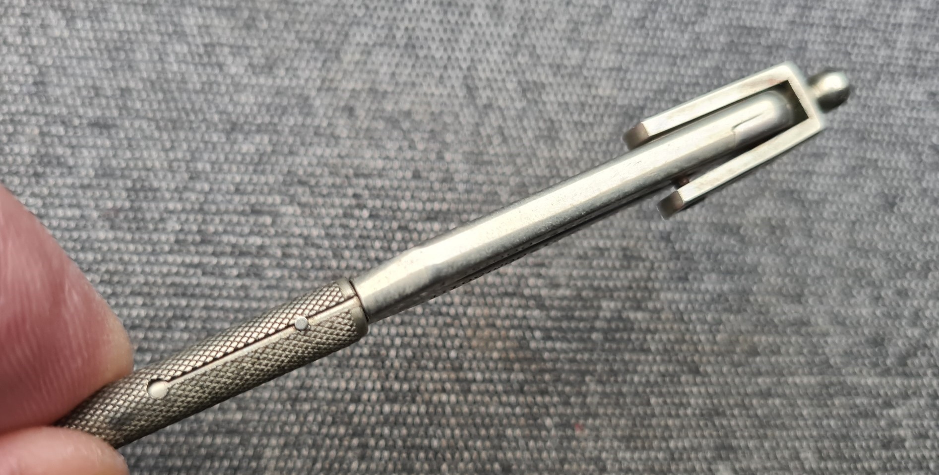 Protective sheath is held firmly in position by clicking cut outs on slot around a pin on the divider leg