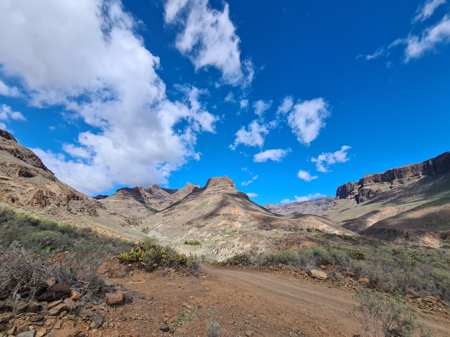 A dirt road leads the way up into the barren barrancos