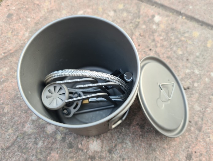 Petrel Remote Stove easily fits inside a Toaks 750ml pot. There is no room for a gas canister but a lighter, folding spork and brew kit could nestle alongside
